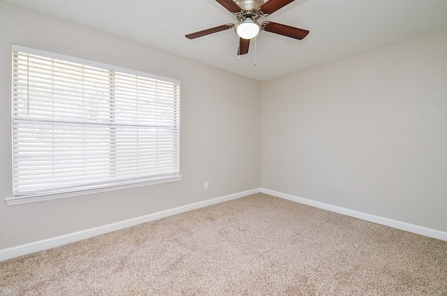 spare room with ceiling fan, carpet flooring, and baseboards