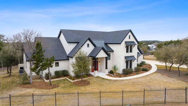 modern farmhouse style home featuring a front yard