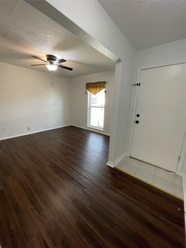 entrance foyer featuring ceiling fan, wood-type flooring, and a textured ceiling