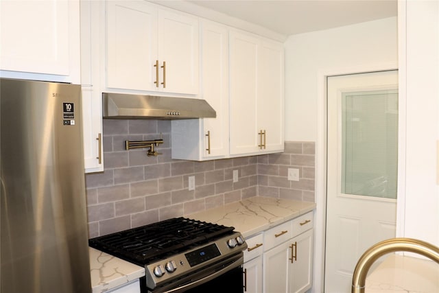 kitchen featuring stainless steel appliances, white cabinetry, tasteful backsplash, and light stone counters