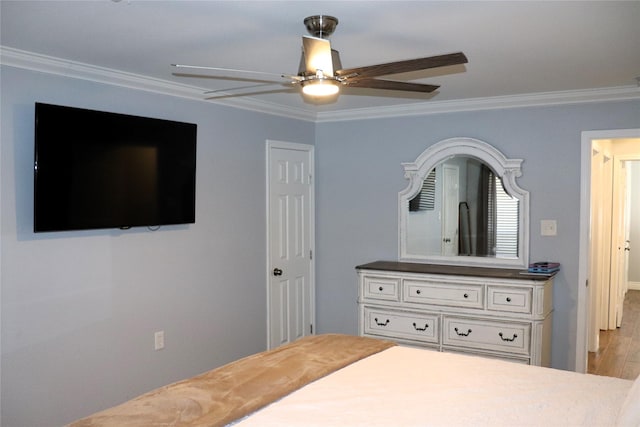 bedroom featuring crown molding, ceiling fan, and light wood-type flooring