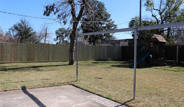 view of yard featuring a playground and a patio