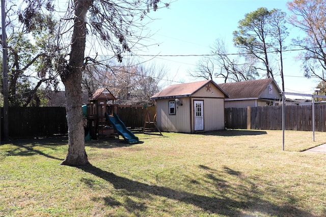 view of yard with a storage shed and a playground