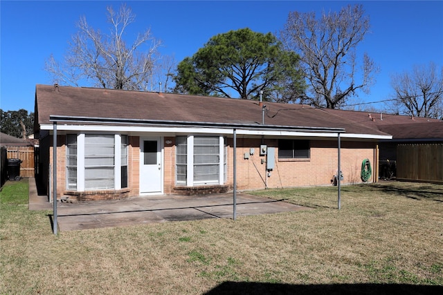 back of house featuring a yard and a patio