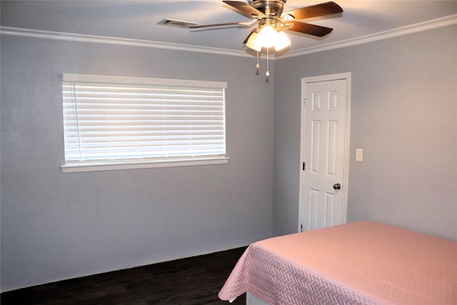 bedroom featuring ornamental molding, dark wood-type flooring, and ceiling fan