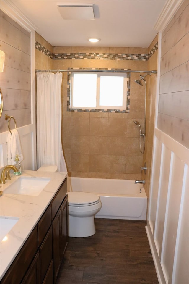 full bathroom featuring wooden walls, vanity, wood-type flooring, shower / bath combination with curtain, and toilet