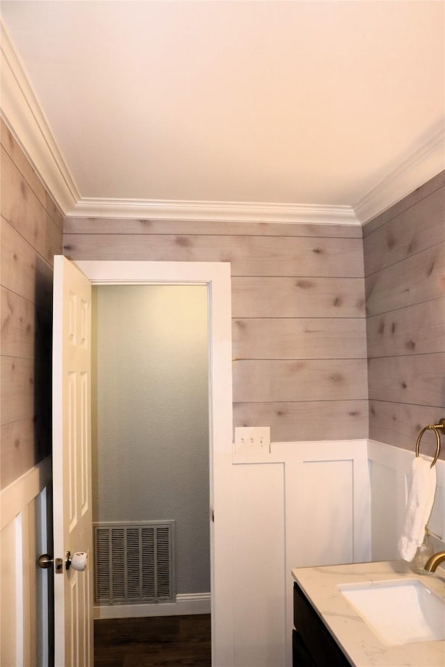 bathroom with crown molding and vanity