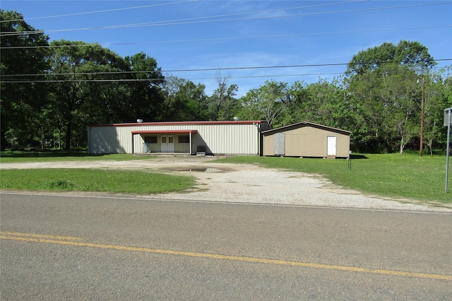 view of outdoor structure featuring a lawn