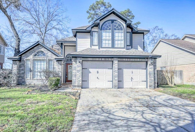 view of front of property featuring a garage, a front lawn, and concrete driveway