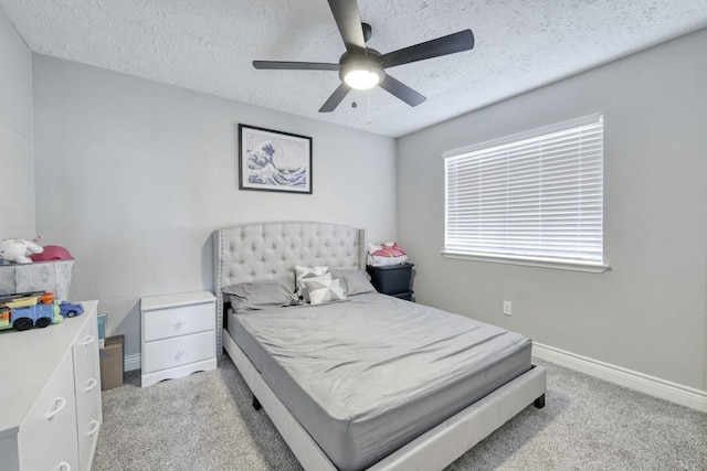 bedroom with a textured ceiling, baseboards, a ceiling fan, and light colored carpet