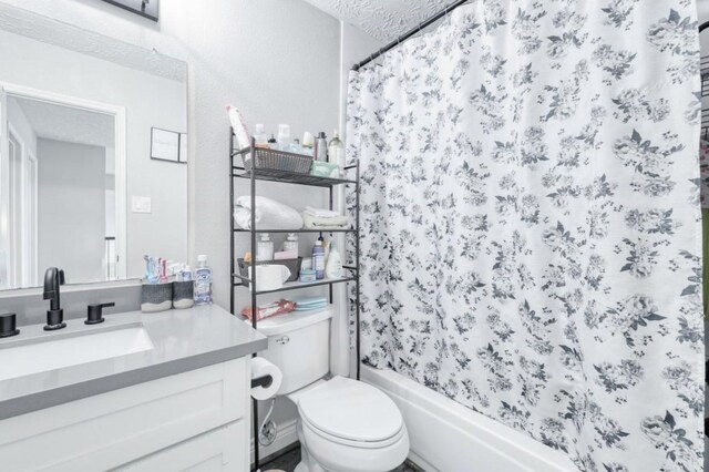 full bathroom with shower / tub combo, vanity, and toilet