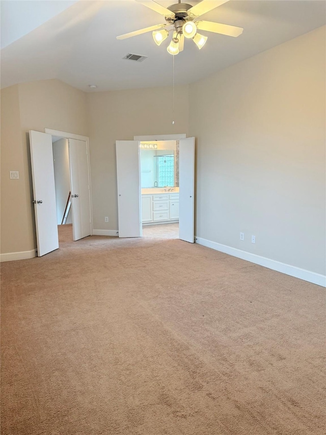 carpeted spare room featuring ceiling fan and lofted ceiling