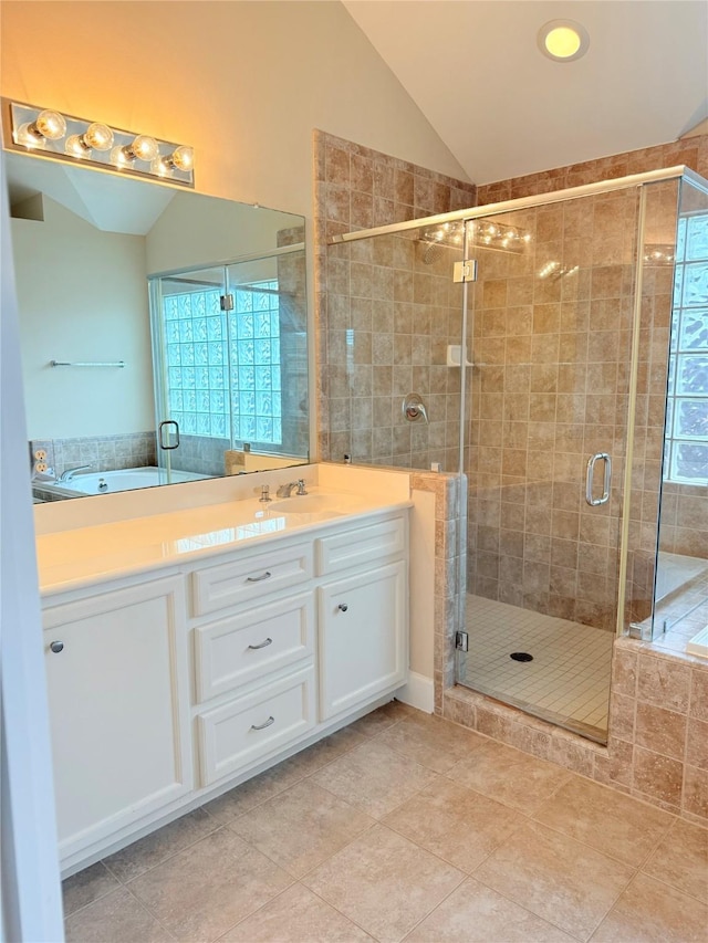 bathroom with vanity, lofted ceiling, tile patterned floors, and walk in shower