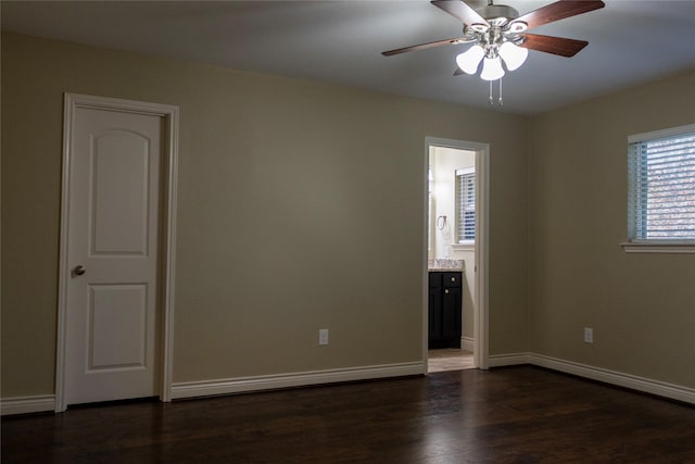 spare room featuring dark wood-type flooring and ceiling fan