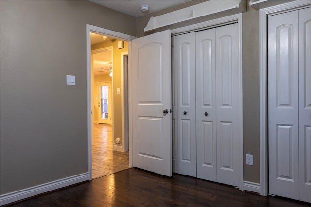 unfurnished bedroom with dark hardwood / wood-style floors