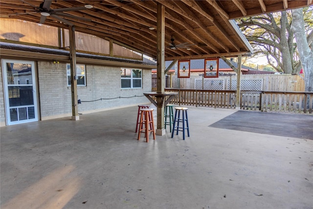 view of patio featuring an outdoor bar and ceiling fan