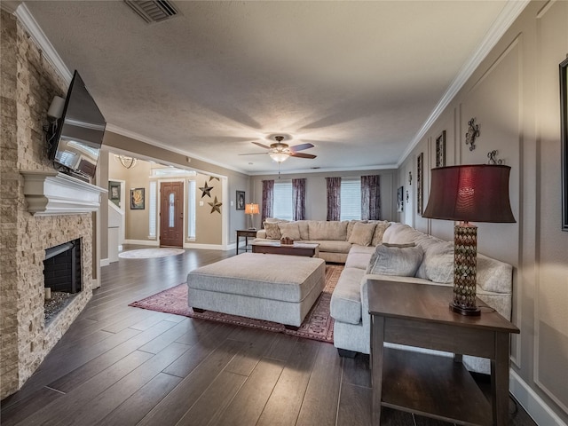 living room with ornamental molding, dark hardwood / wood-style floors, and a textured ceiling