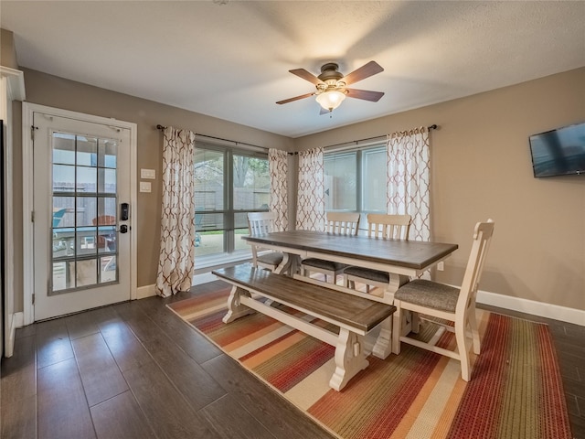 unfurnished dining area with ceiling fan and dark hardwood / wood-style floors