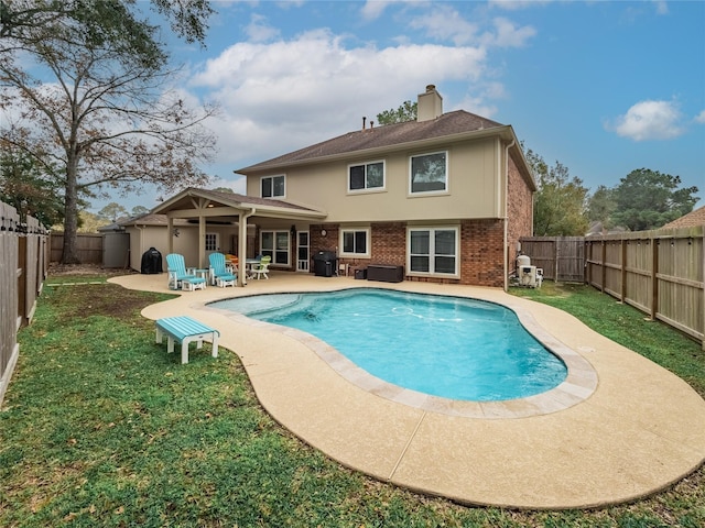 view of swimming pool with grilling area and a patio area