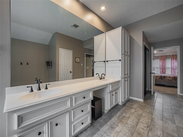 bathroom featuring ceiling fan and vanity