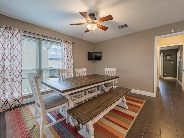 dining room featuring ceiling fan and dark hardwood / wood-style flooring