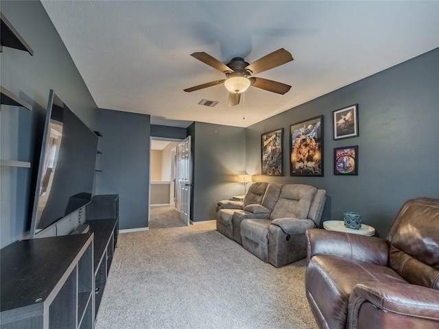 carpeted living room with ceiling fan