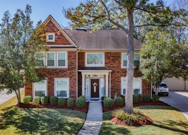 view of front facade with a garage and a front lawn