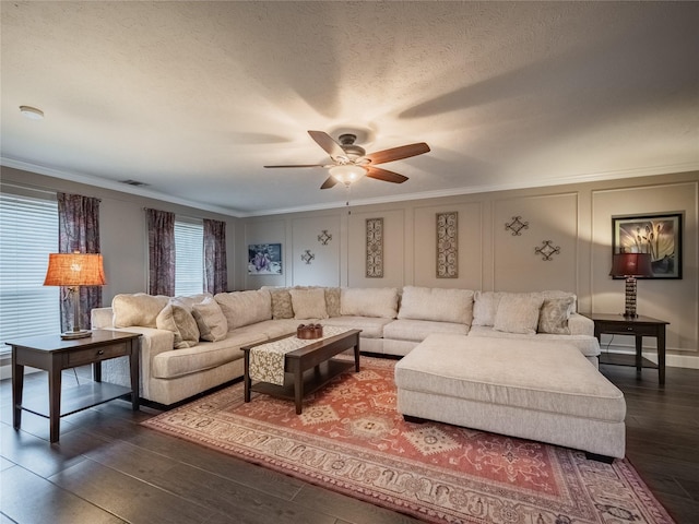 living room featuring crown molding, ceiling fan, a textured ceiling, and dark hardwood / wood-style flooring