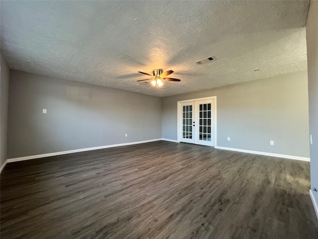 unfurnished room featuring ceiling fan, a textured ceiling, dark hardwood / wood-style flooring, and french doors