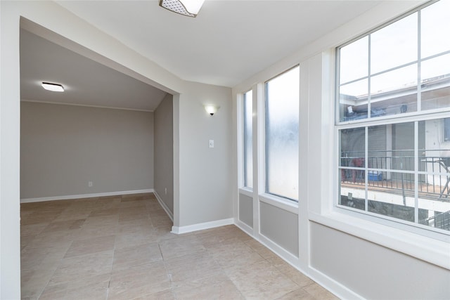 unfurnished room with plenty of natural light and light tile patterned floors