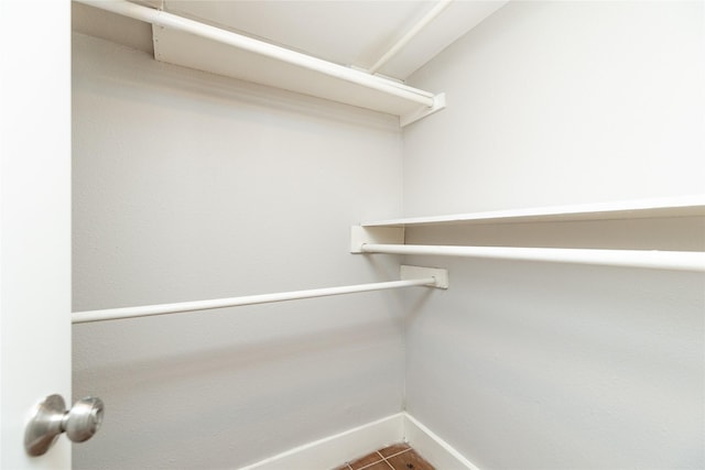 walk in closet with tile patterned floors