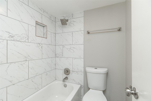 bathroom featuring toilet and tiled shower / bath combo