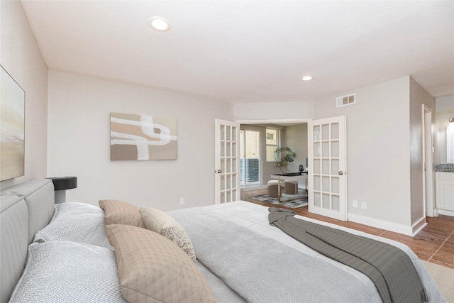 bedroom with wood-type flooring and french doors