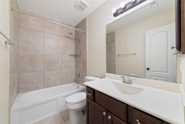 full bathroom with vanity, tiled shower / bath combo, tile patterned floors, and toilet