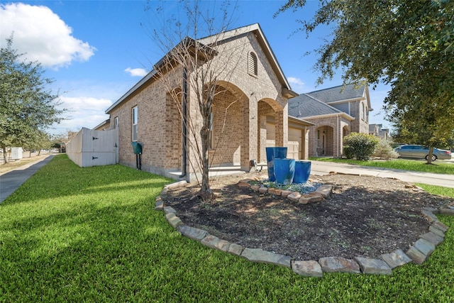 view of front of home featuring a garage and a front lawn