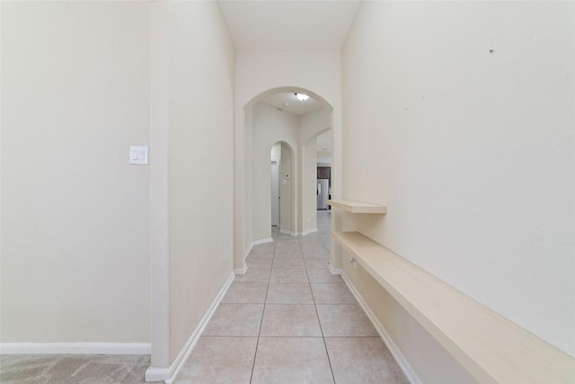 corridor with light tile patterned floors