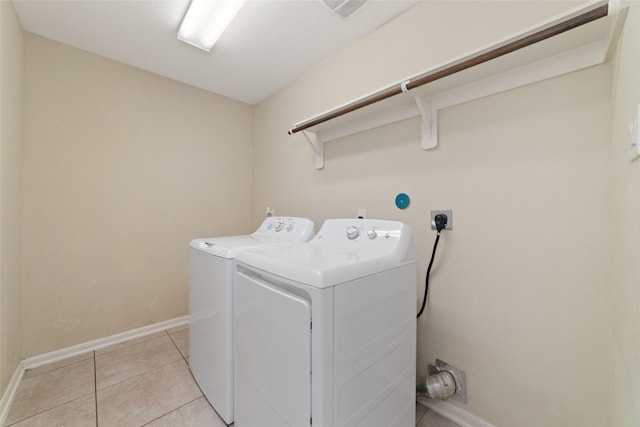 washroom with light tile patterned flooring and separate washer and dryer