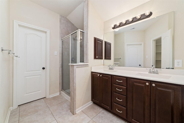 bathroom with tile patterned floors, a shower with shower door, and vanity