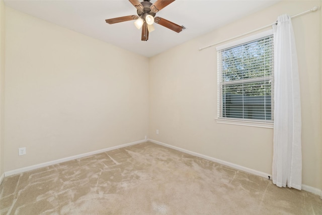 empty room featuring light carpet and ceiling fan