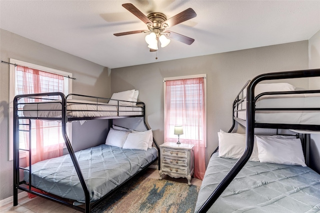 bedroom featuring multiple windows and ceiling fan