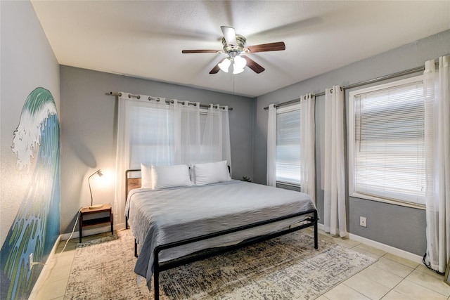 tiled bedroom with ceiling fan