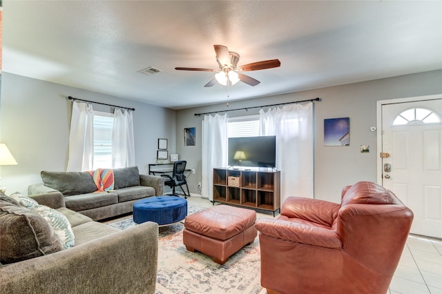 living room with light tile patterned floors and ceiling fan