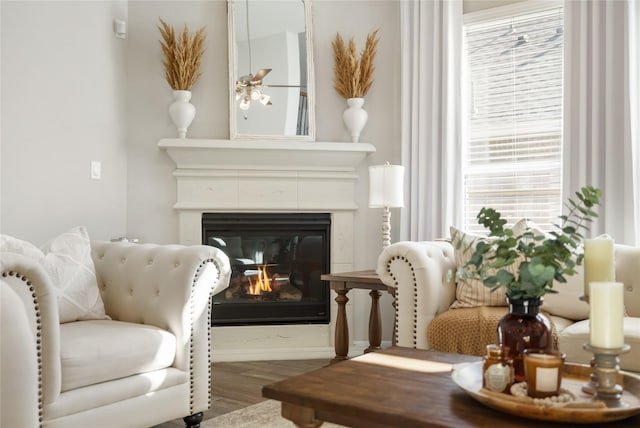 sitting room with ceiling fan and hardwood / wood-style floors