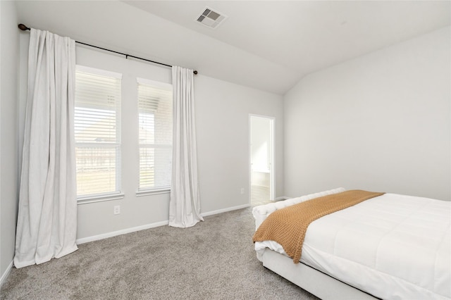 bedroom featuring vaulted ceiling and light carpet