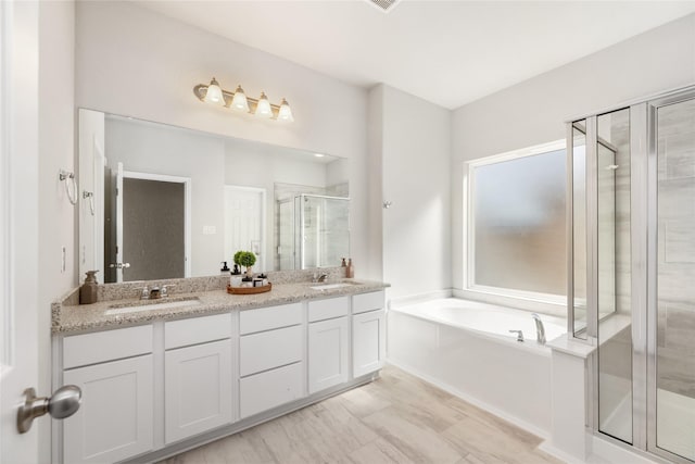 bathroom featuring vanity and plus walk in shower