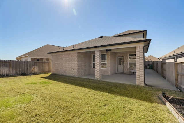 back of house featuring a patio and a lawn