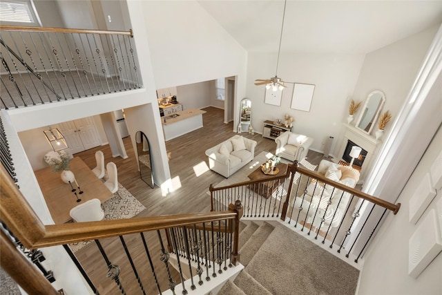 stairway featuring hardwood / wood-style floors and high vaulted ceiling