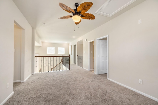 carpeted spare room with ceiling fan