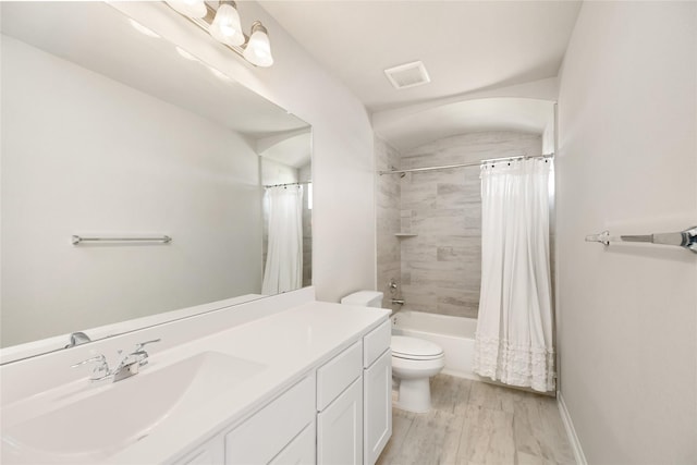 full bathroom featuring vanity, hardwood / wood-style floors, toilet, and shower / bath combo with shower curtain