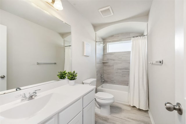 full bathroom with vanity, toilet, and shower / bath combo with shower curtain